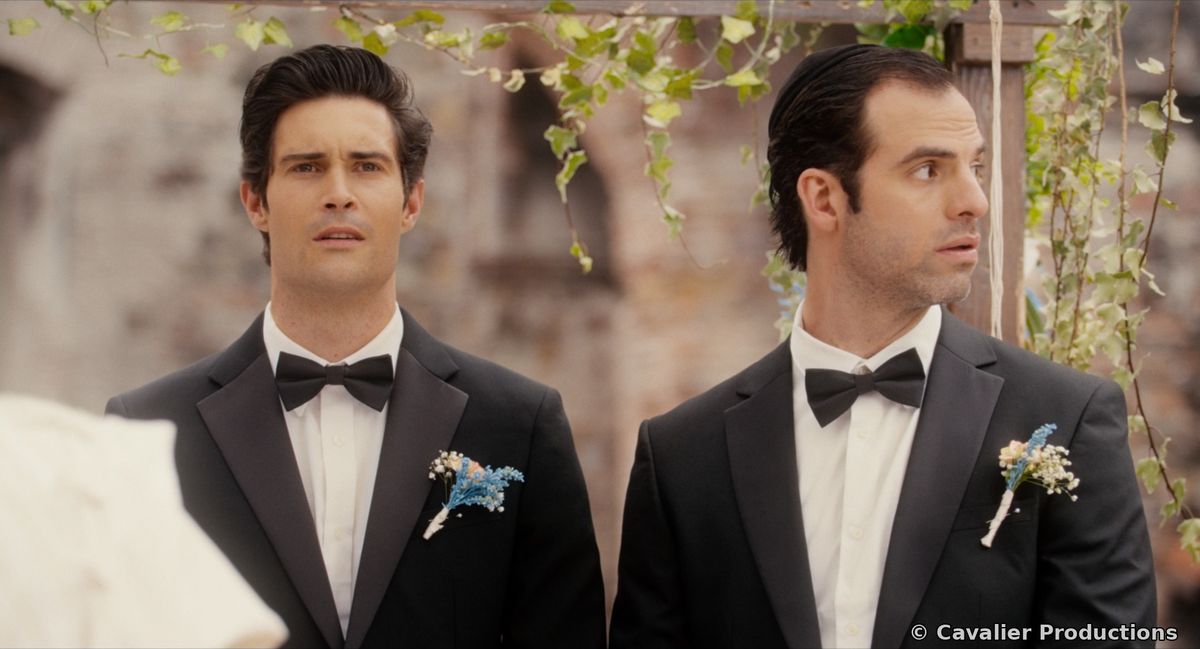 Dan and Simon in tuxedos at the altar